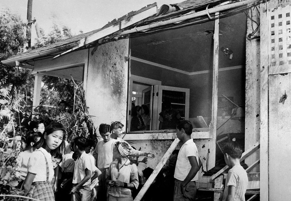 A small crowd inspects the damage, both inside and outside, afte