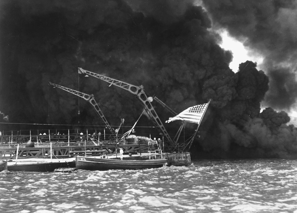 A U.S. flag flies from the stern of the sunken battleship USS We