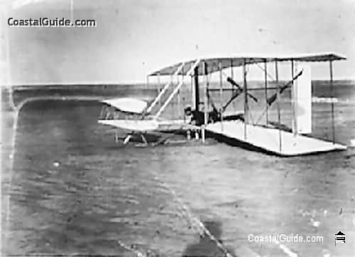 Wilbur Wright in damaged machine after unsuccessful trial, Dec. 