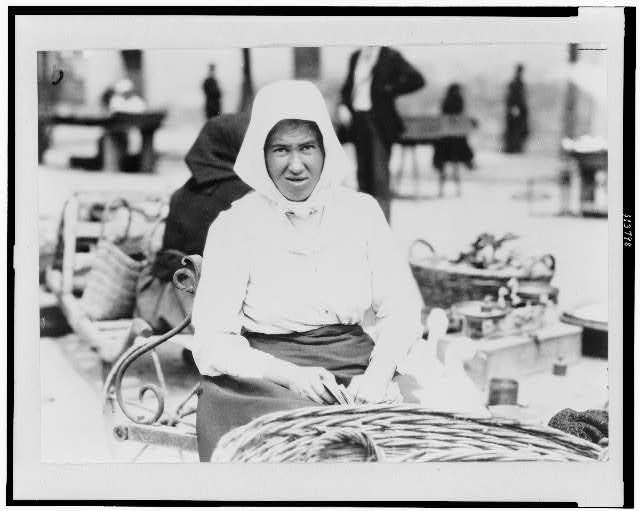 Woman with basket in market, Hungary 1923