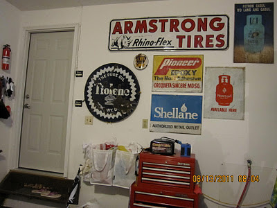 American and Philippine petroliana signs hanging in garage