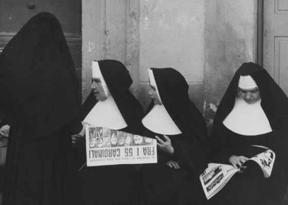 Nuns reading about Pope Pius XII's death.