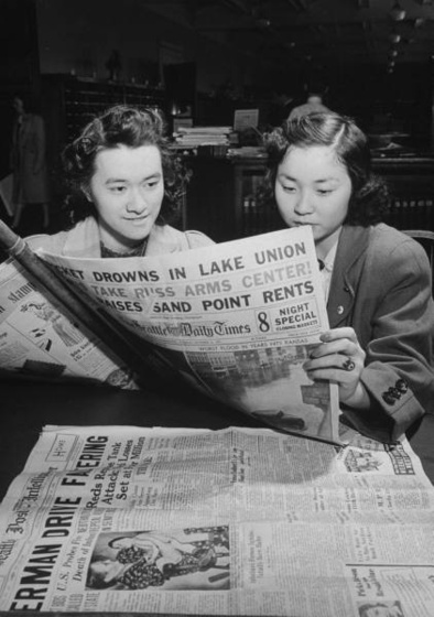 Two women reading a newspaper in the Congressional Library's New