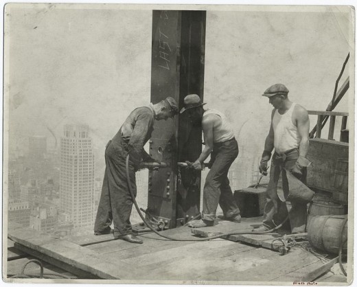 Three-workers-securing-a-rivet-1931-520x418