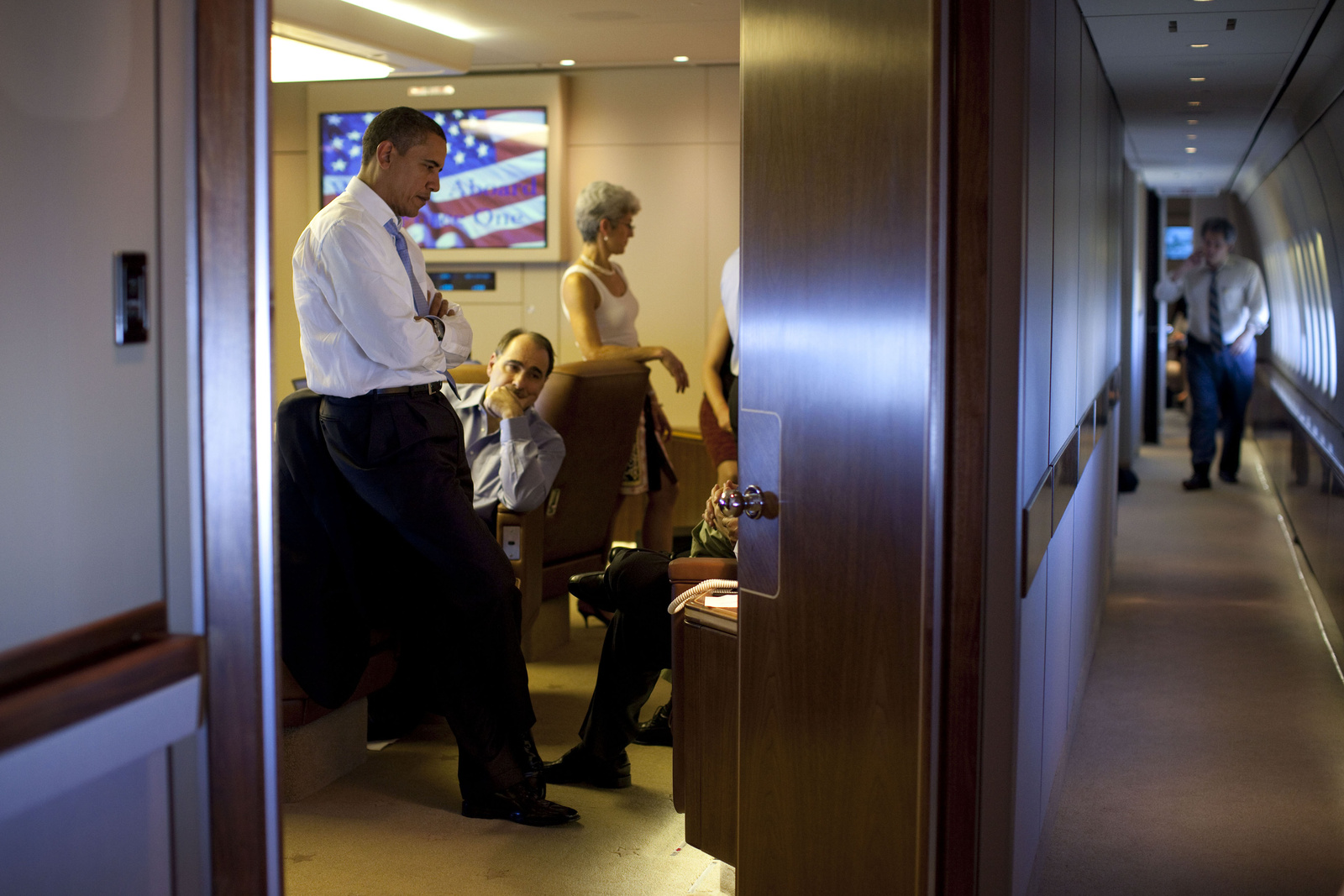 President Obama Confers with Aides on Air Force One