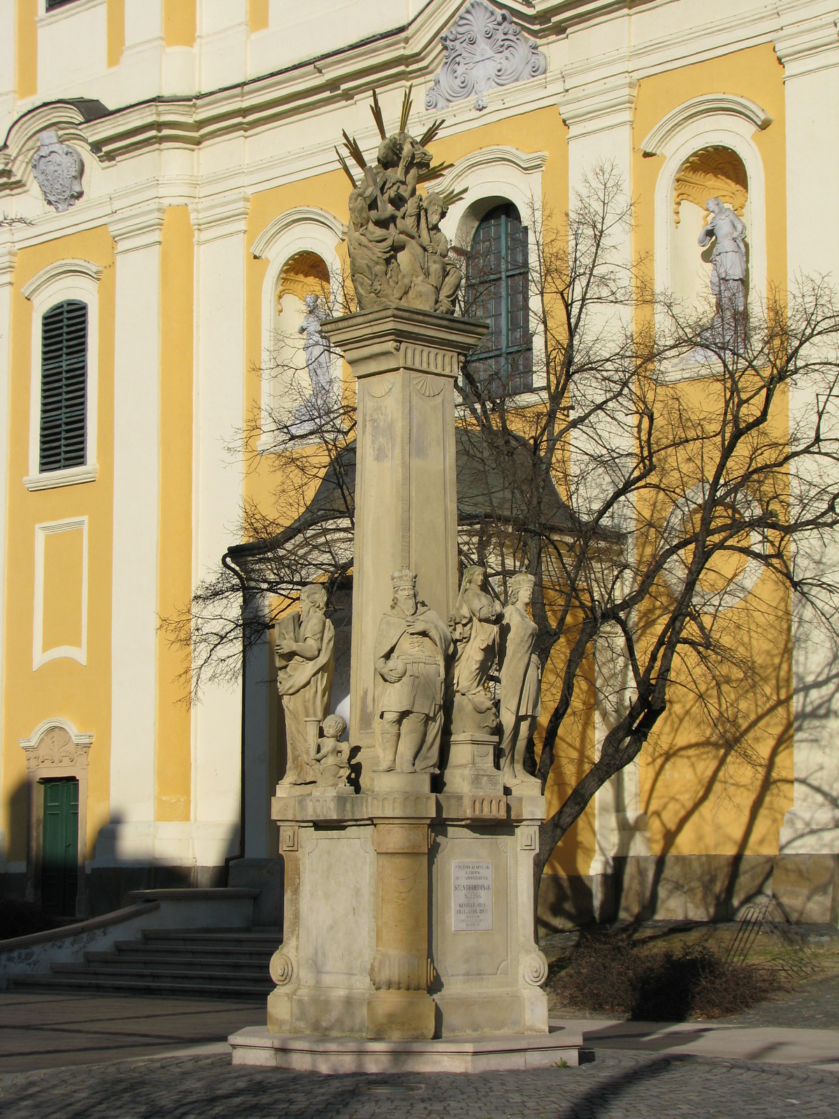 Szentháromság szobor a templom bejáratánál.